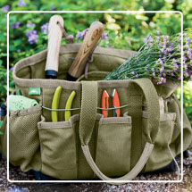 Puddleproof Tote filled with garden supplies on patio next to garden bed