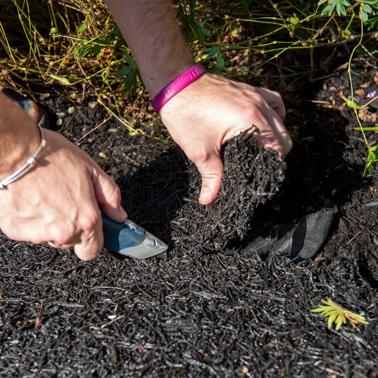 Person using Xacto Knife to cut strips of Recycled Rubber Walkway