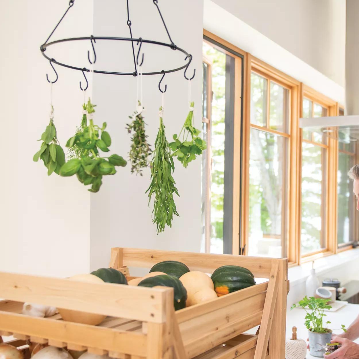 Herb Drying Rack with green herbs hanging from it