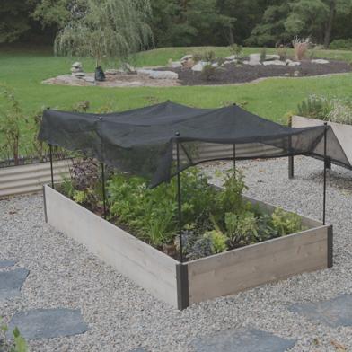 Shade Kit covering crops in wooden raised bed 