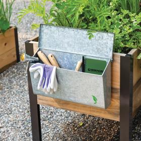 Galvanized Tool Storage Box with gardening tools inside hanging on the side of an elevated garden bed