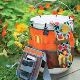 Womanswork Bucket Caddy on stone walkway filled with garden supplies