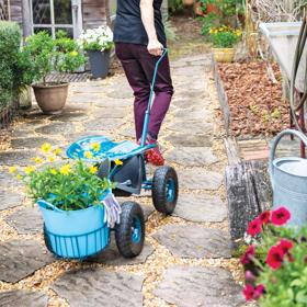 Storm blue Tractor Scoot with Tubtrug being pulled along a path of stepping stones