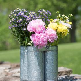 Galvanized Flower Caddy filled with spring blooms on a stone step