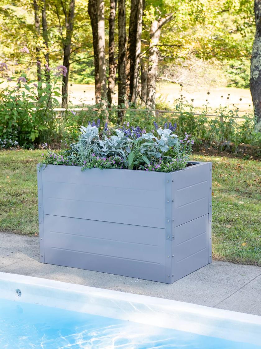 Light blue Putnam Metal Raised Bed 24" x 45" (30" D) planted up at edge of pool