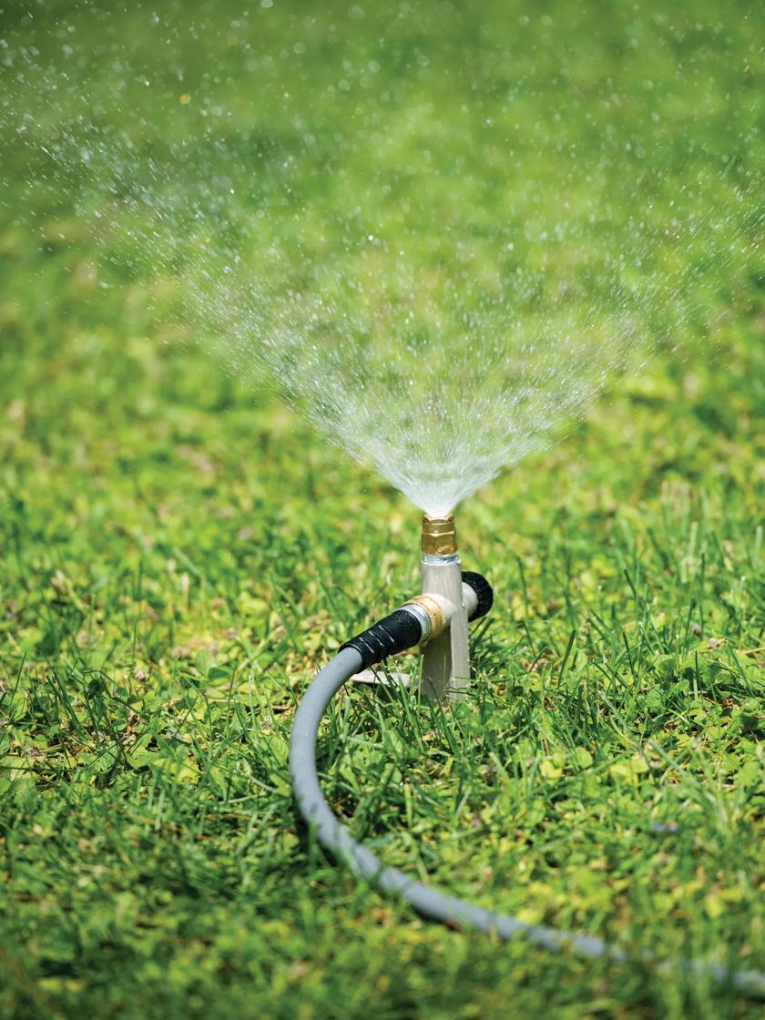 lawn sprinkler head spraying water