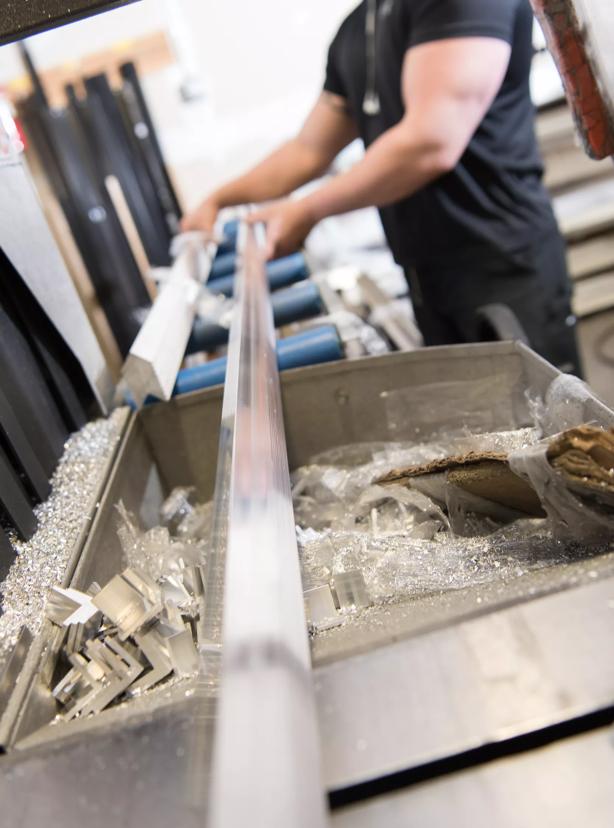 Machinist cutting aluminum corners to size